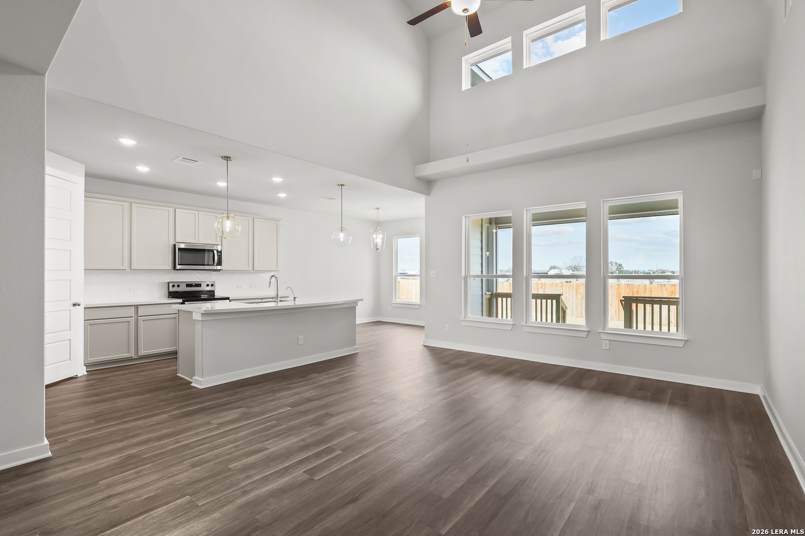 165 Mallorys Way Castroville, TX 78009 - Photo 4 of 34 a large kitchen with cabinets wooden floor and a large window