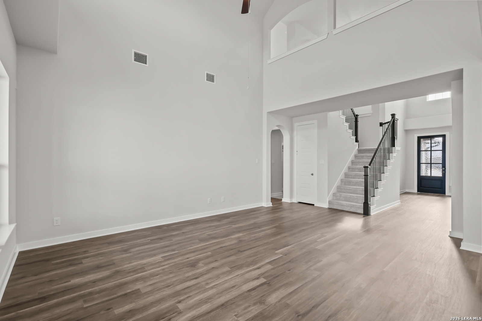 165 Mallorys Way Castroville, TX 78009 - Photo 6 of 34 a view of an empty room with stairs and a ceiling fan