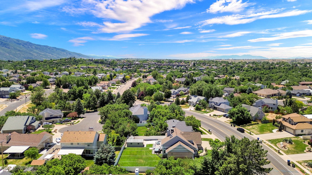 4792 Glasmann Way South Ogden, UT 84403 - Photo 19 of 70 Sprawling residential landscape featuring mature trees, diverse custom architectural style homes, and distant mountain ranges