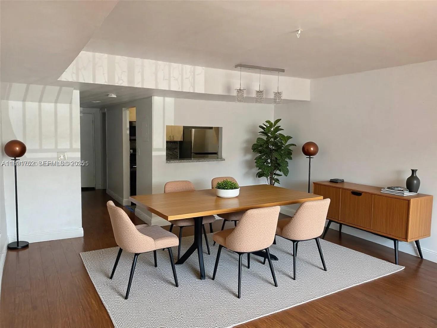 250 Northwest 107th Avenue, Unit 222 Miami, FL 33172 - Photo 2 of 10 a dining room with furniture and wooden floor