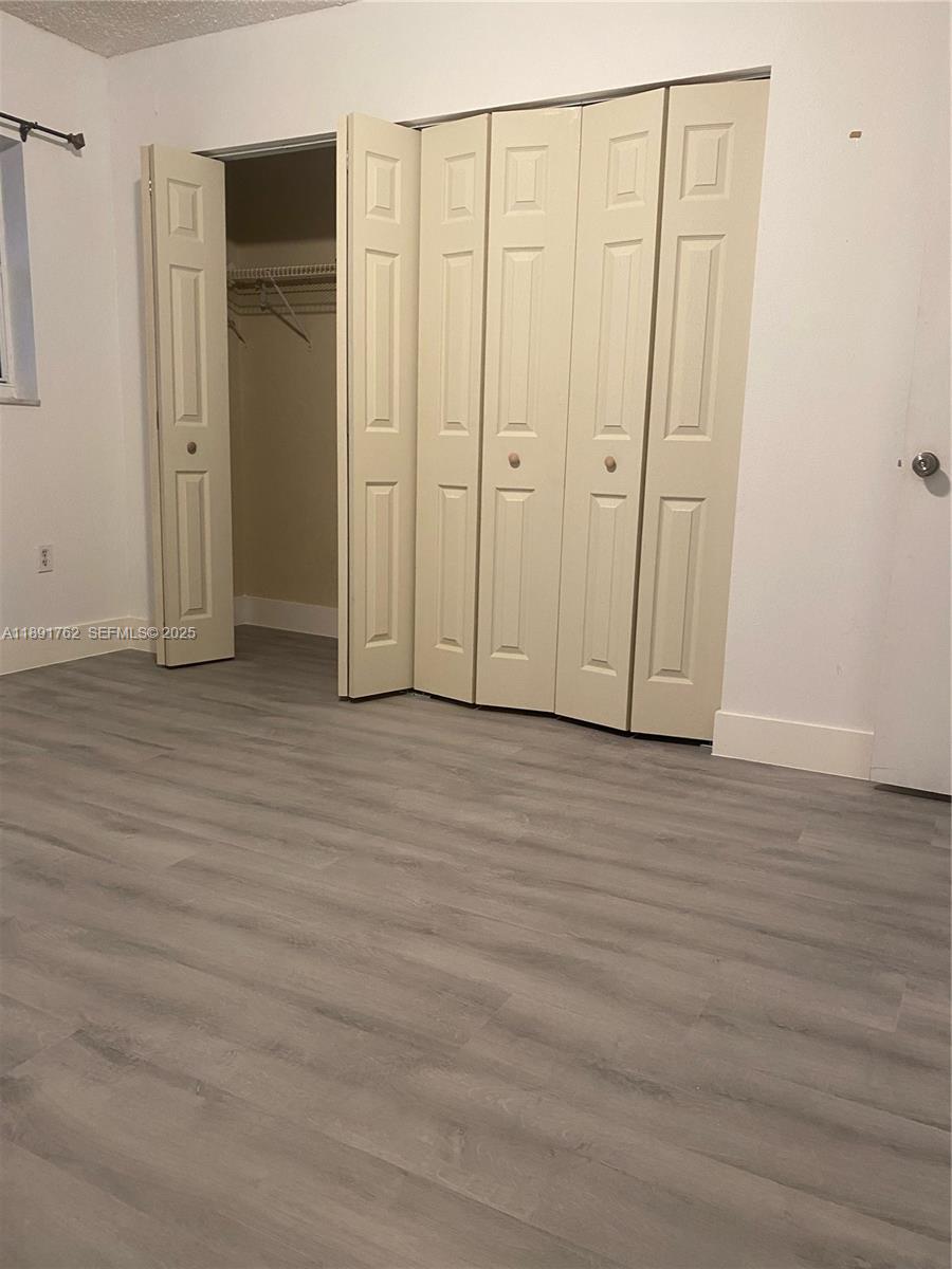250 Northwest 107th Avenue, Unit 222 Miami, FL 33172 - Photo 7 of 10 a view of empty room with wooden floor