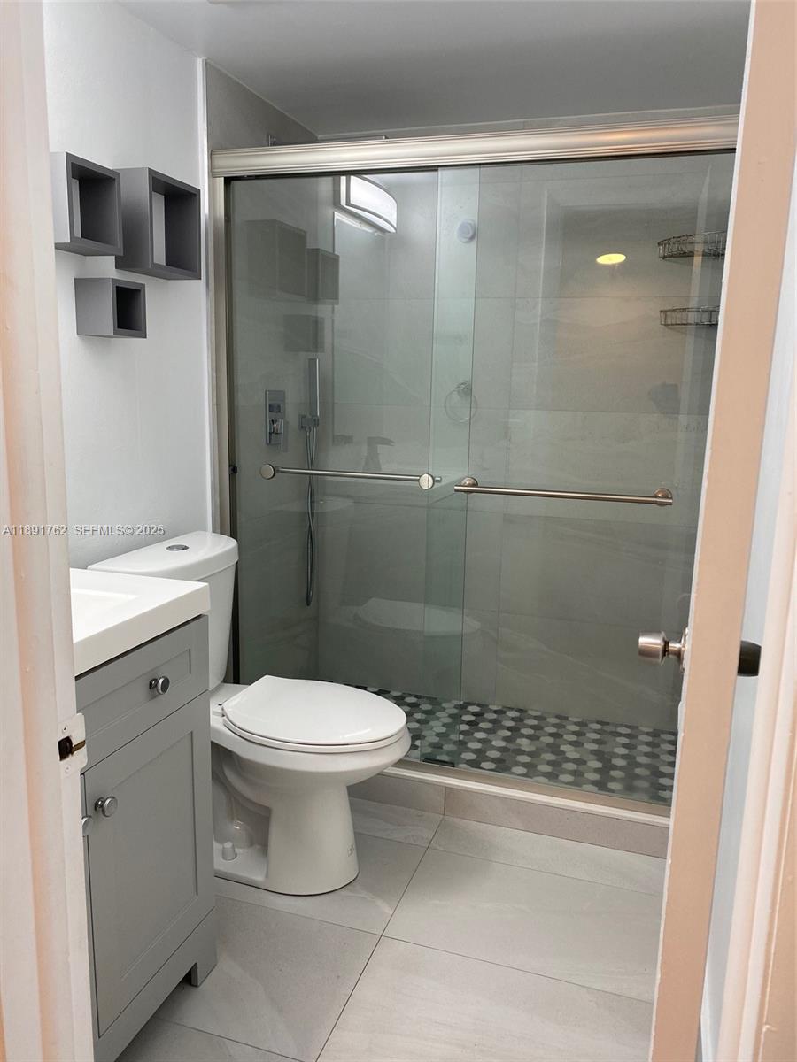 250 Northwest 107th Avenue, Unit 222 Miami, FL 33172 - Photo 9 of 10 a bathroom with a toilet and a shower