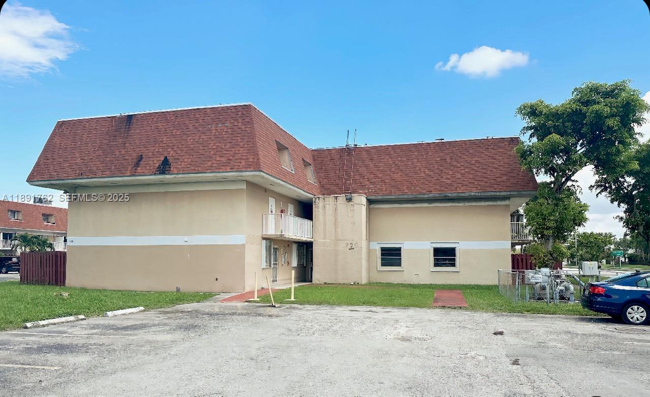 250 Northwest 107th Avenue, Unit 222 Miami, FL 33172 - Photo 10 of 10 a view of a house with a yard and garage