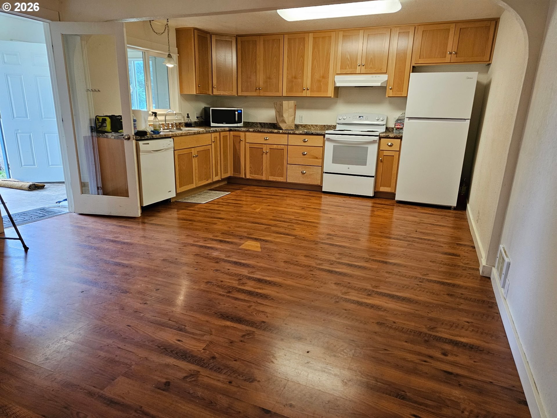 33802 Market Road Creswell, OR 97426 - Photo 4 of 30 a kitchen with granite countertop a refrigerator and wooden floors