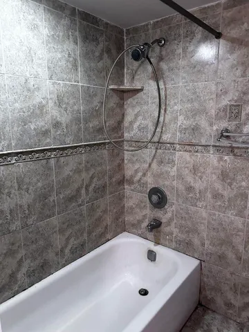 a bathroom with a granite countertop sink a mirror and shower