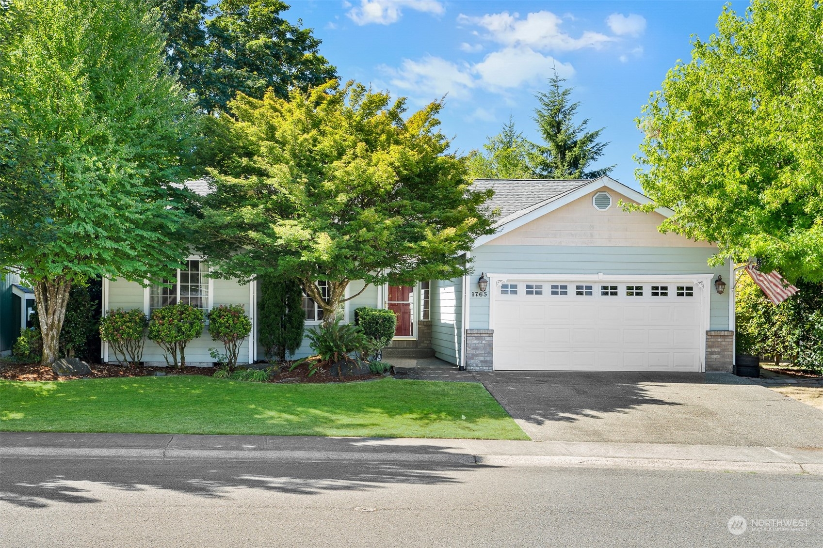 a front view of house with a garden