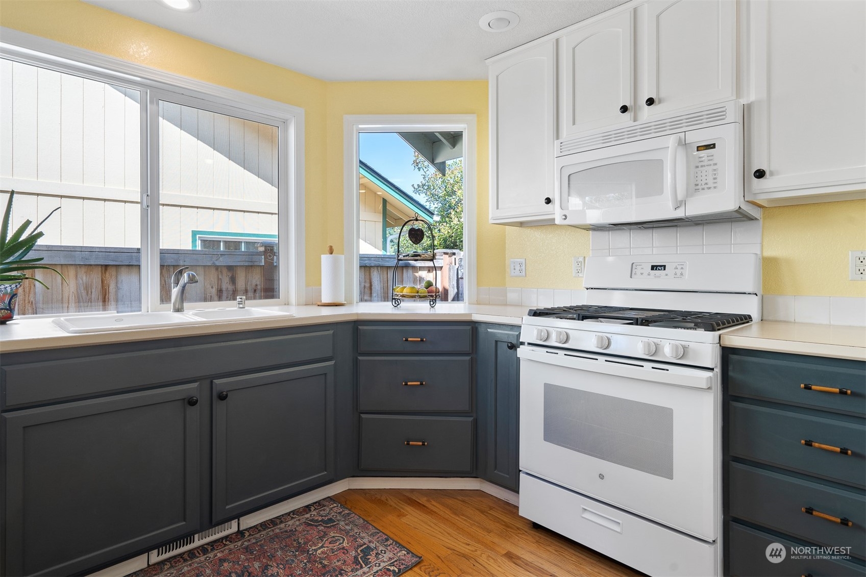 1765 53rd Loop Southeast Olympia, WA 98501 - Photo 14 of 34 a kitchen with a stove white cabinets and a window