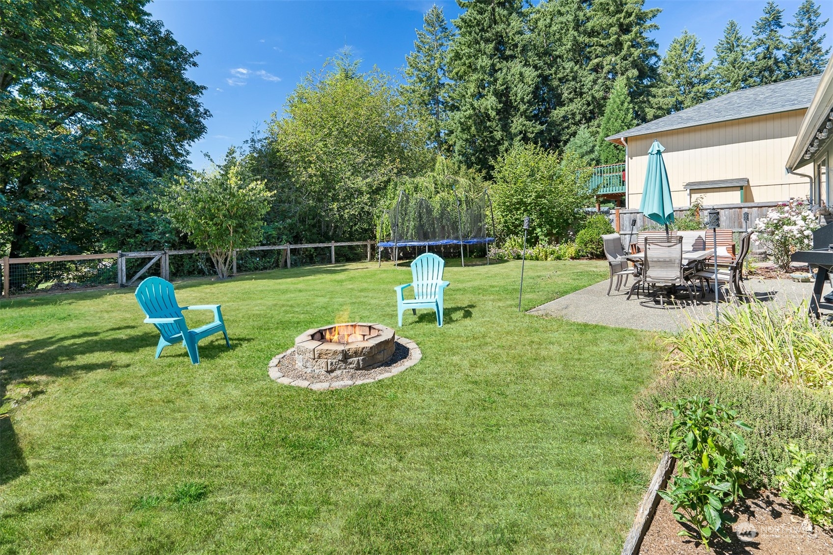 1765 53rd Loop Southeast Olympia, WA 98501 - Photo 32 of 34 a view of a backyard with chairs and a garden