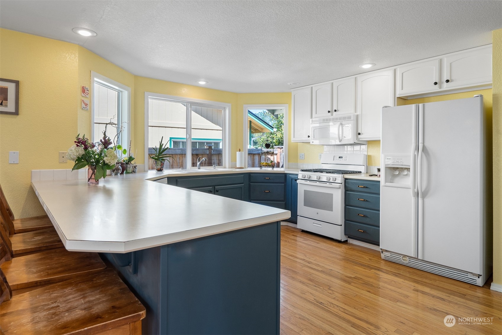 1765 53rd Loop Southeast Olympia, WA 98501 - Photo 9 of 34 a kitchen with stainless steel appliances a sink a stove a refrigerator with a dining table and chairs