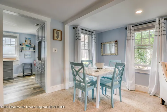 a view of a dining room with furniture and a window