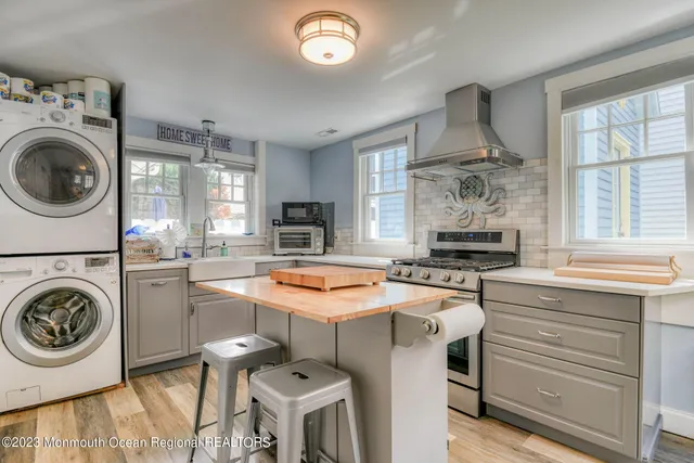 a kitchen with kitchen island a stove a sink and a refrigerator