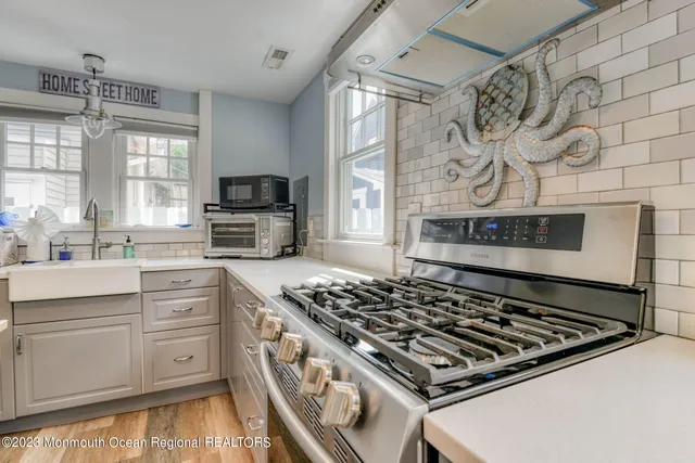 a kitchen with stainless steel appliances granite countertop a stove and a sink