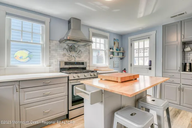 a kitchen with stainless steel appliances granite countertop a sink and a stove