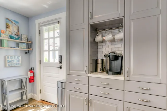 a kitchen with a refrigerator and cabinets