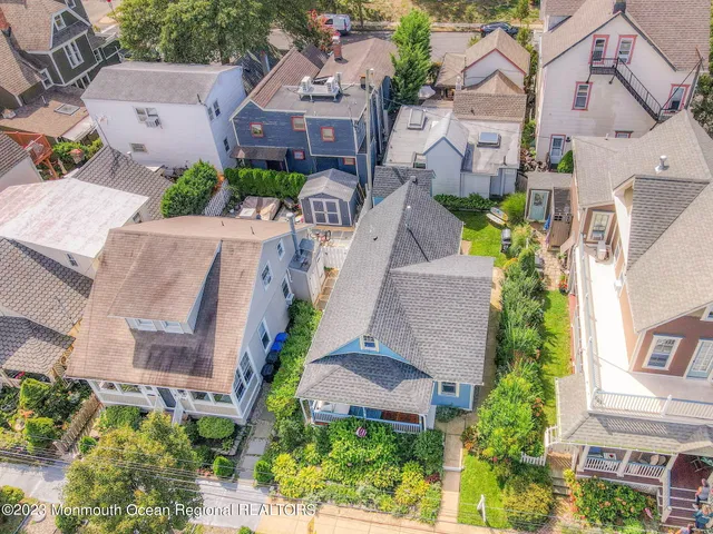 an aerial view of multiple houses with a yard