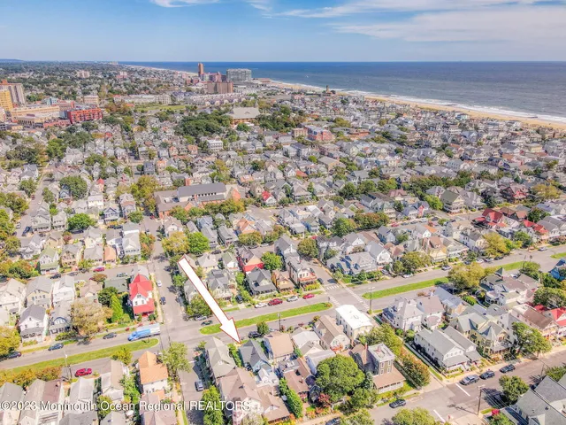 a view of a white house next to a yard