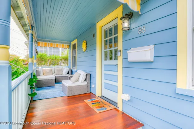 a balcony with couch and wooden floor