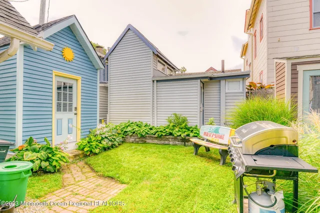 a view of a house with backyard and sitting area