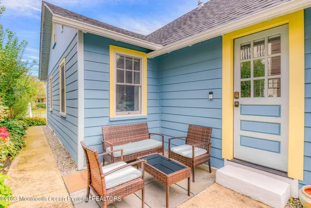 a front view of a house with outdoor seating