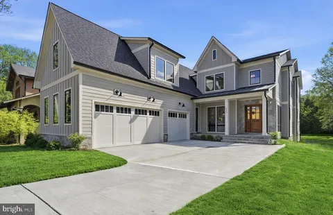 a front view of a house with a yard and porch