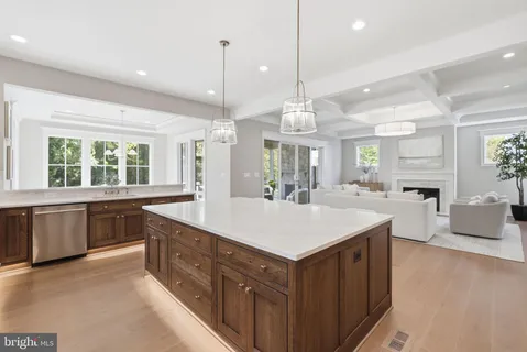 a kitchen with a table chairs sink and cabinets