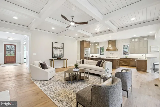 a living room with furniture and view of kitchen