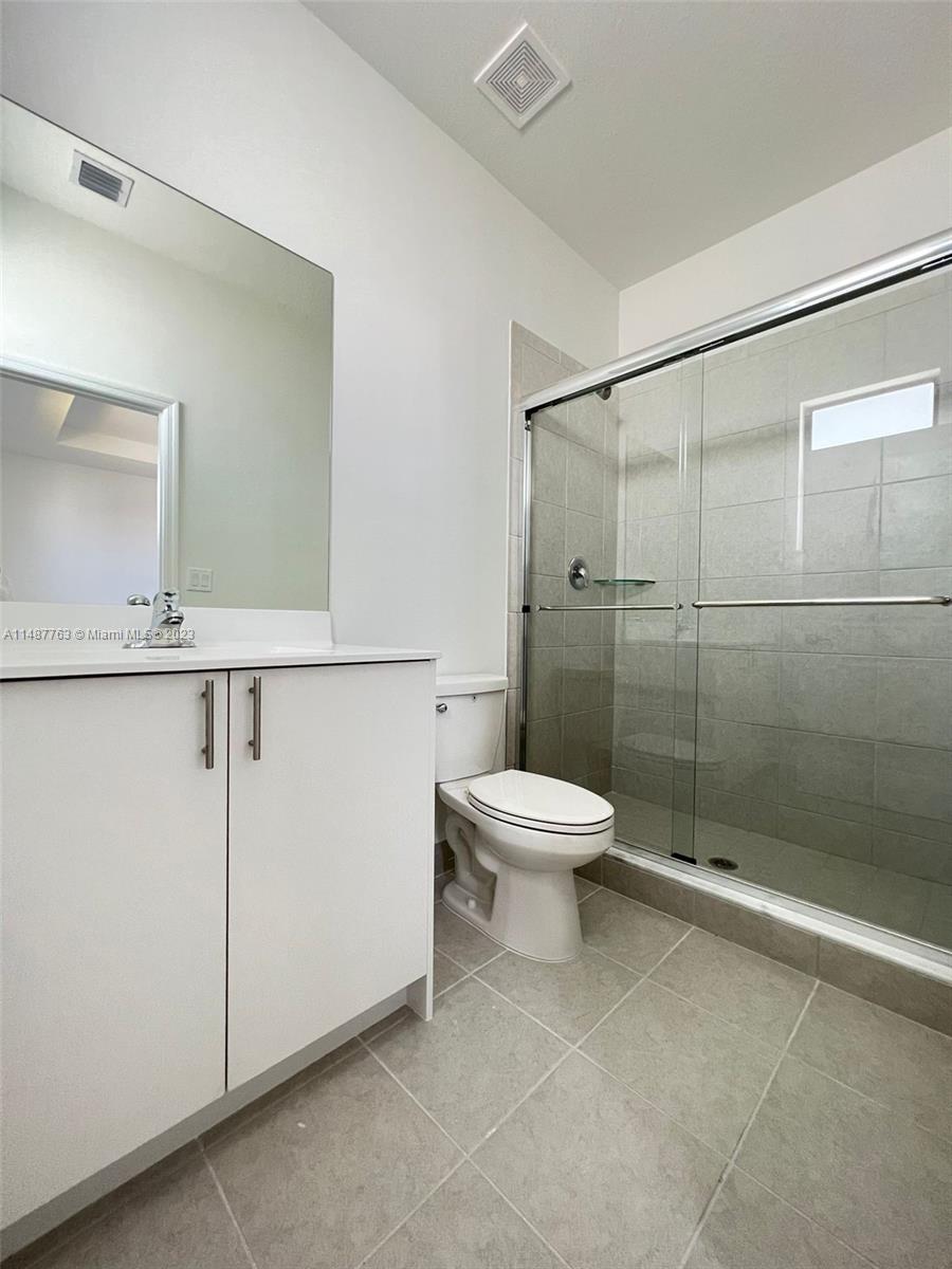 12765 Southwest 234th Terrace Homestead, FL 33032 - Photo 16 of 28 a white toilet sitting next to a bathroom sink