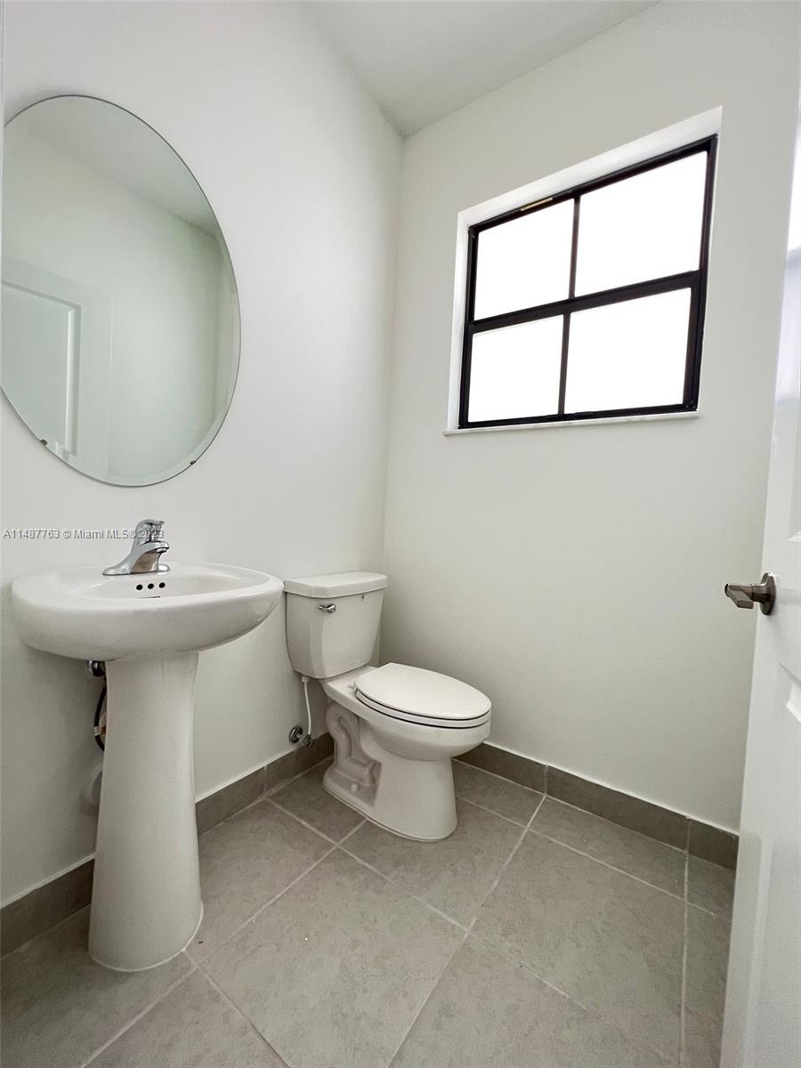 12765 Southwest 234th Terrace Homestead, FL 33032 - Photo 8 of 28 a bathroom with a sink toilet and mirror