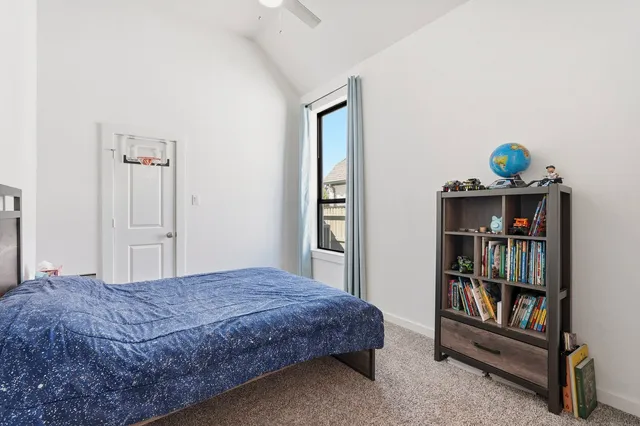 a bedroom with a bed and a book shelf