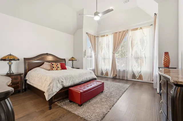 a bedroom with a large bed and a chandelier