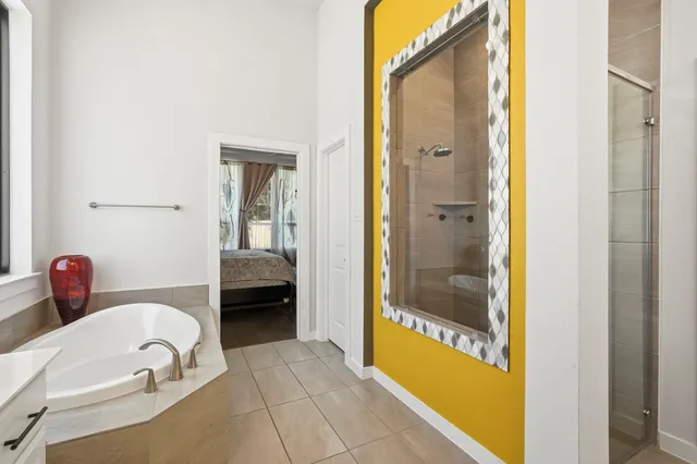 a bathroom with a tub and a view of bathroom