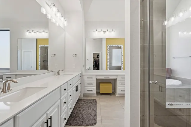 a spacious bathroom with a double vanity sink and a mirror