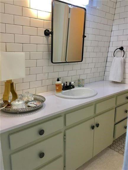 4600 Shoalwood Avenue Austin, TX 78756 - Photo 2 of 6 a bathroom with a sink and a mirror