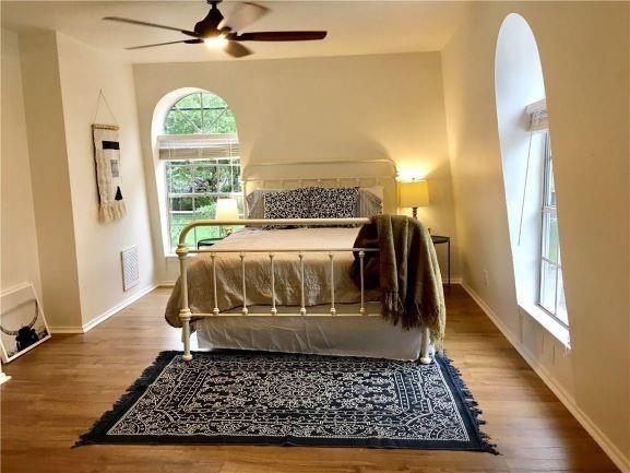 4600 Shoalwood Avenue Austin, TX 78756 - Photo 3 of 6 a bed sitting in a bedroom next to a window