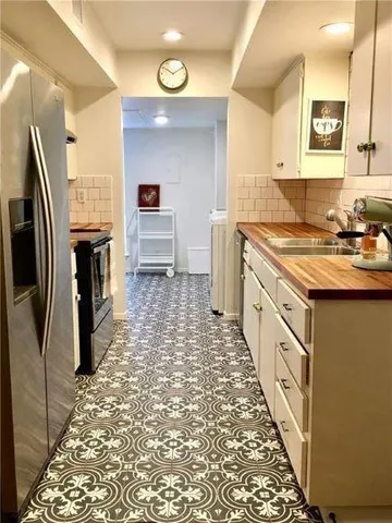 a kitchen with a sink stove and refrigerator