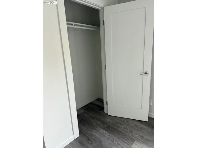 a view of a room with wooden floor