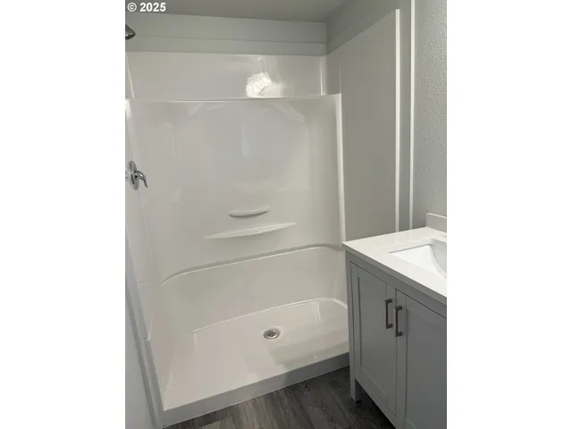 a bathroom with a bathtub and a shower