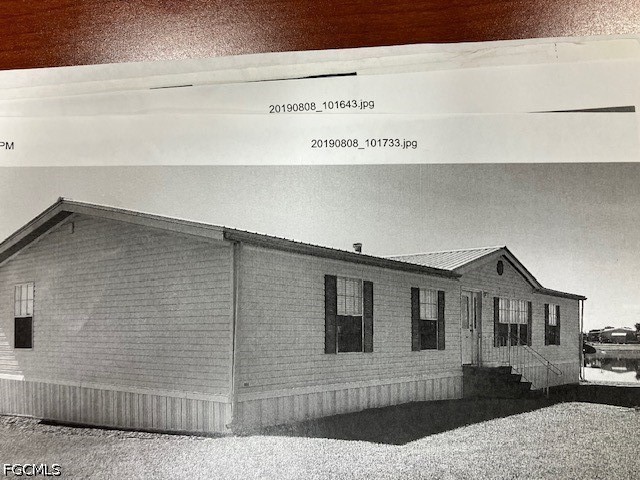 1982 Joshua Boulevard Clewiston, FL 33440 - Photo 2 of 5 a front view of a house with garage