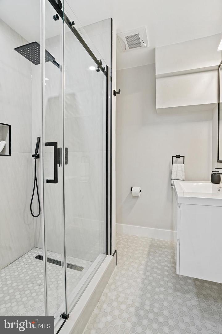 719 Quebec Place Northwest Washington, DC 20010 - Photo 15 of 32 Sleek modern shower with elegant finishes.