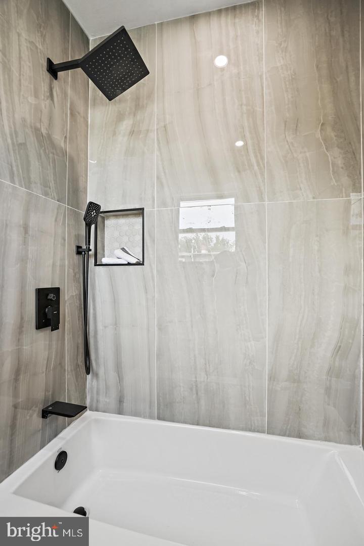 719 Quebec Place Northwest Washington, DC 20010 - Photo 18 of 32 Sleek modern shower with elegant finishes.