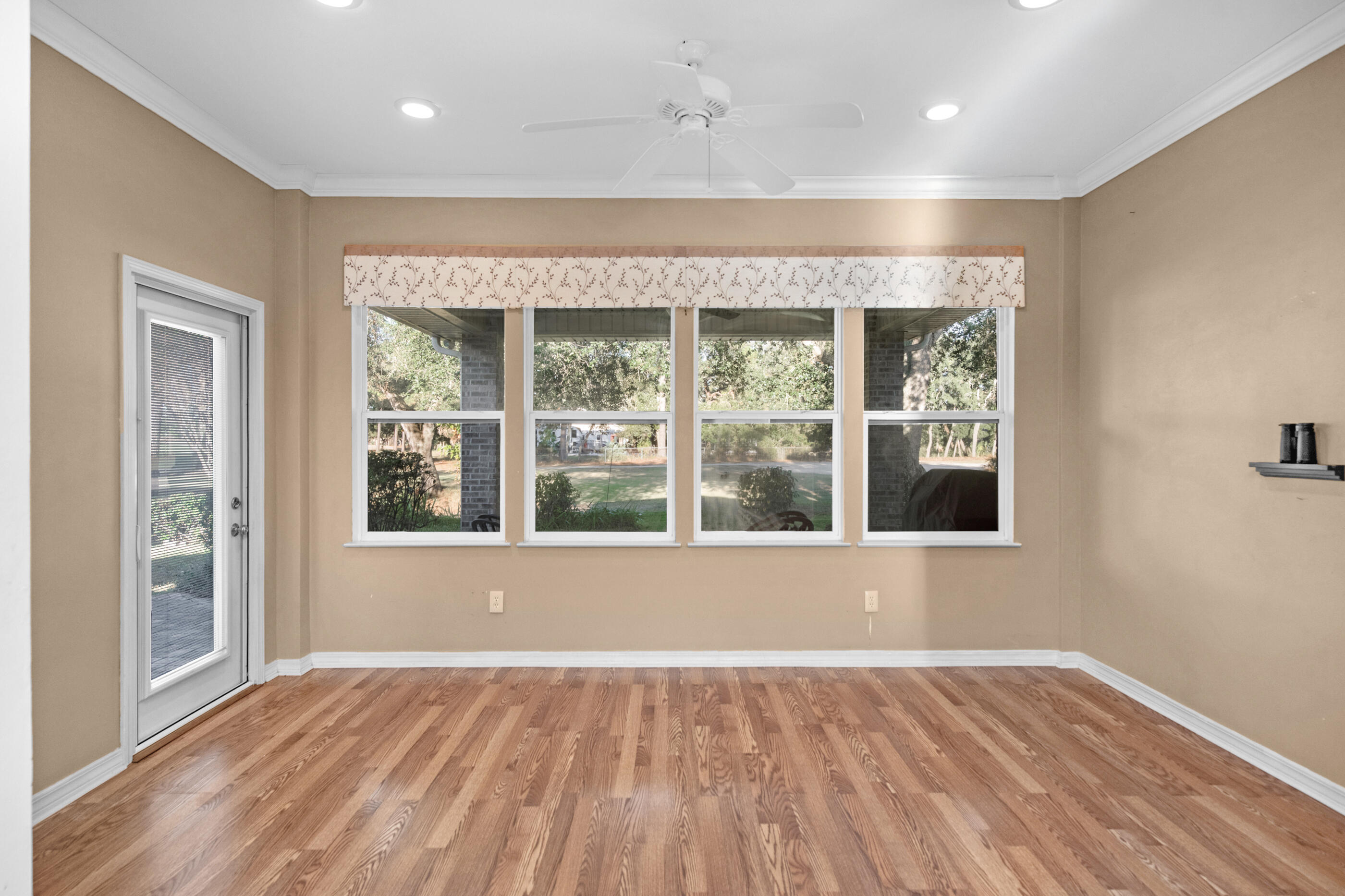 924 Shalimar Point Drive Shalimar, FL 32579 - Photo 15 of 40 an empty room with wooden floor and windows