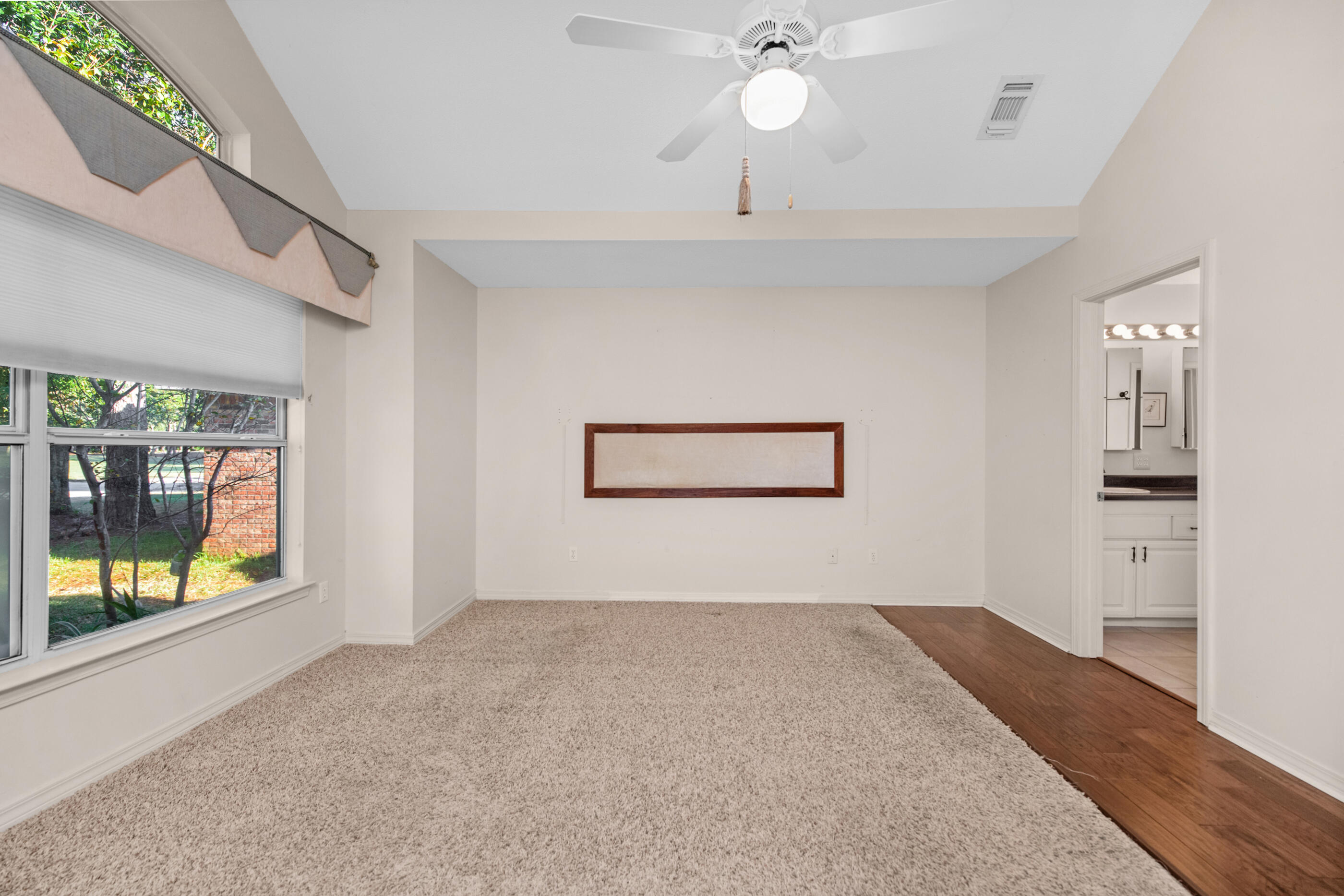 924 Shalimar Point Drive Shalimar, FL 32579 - Photo 16 of 40 en empty room with wooden floor and windows