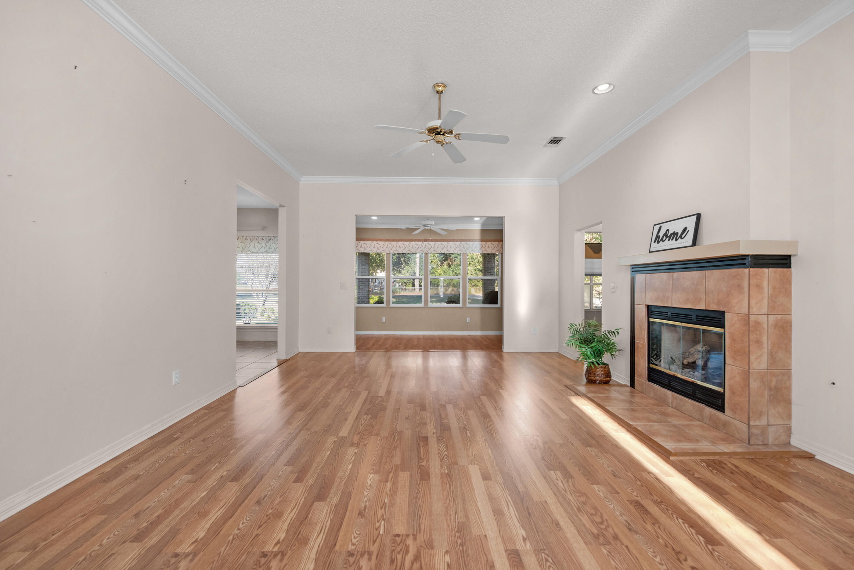 924 Shalimar Point Drive Shalimar, FL 32579 - Photo 31 of 40 an empty room with windows fireplace and wooden floor