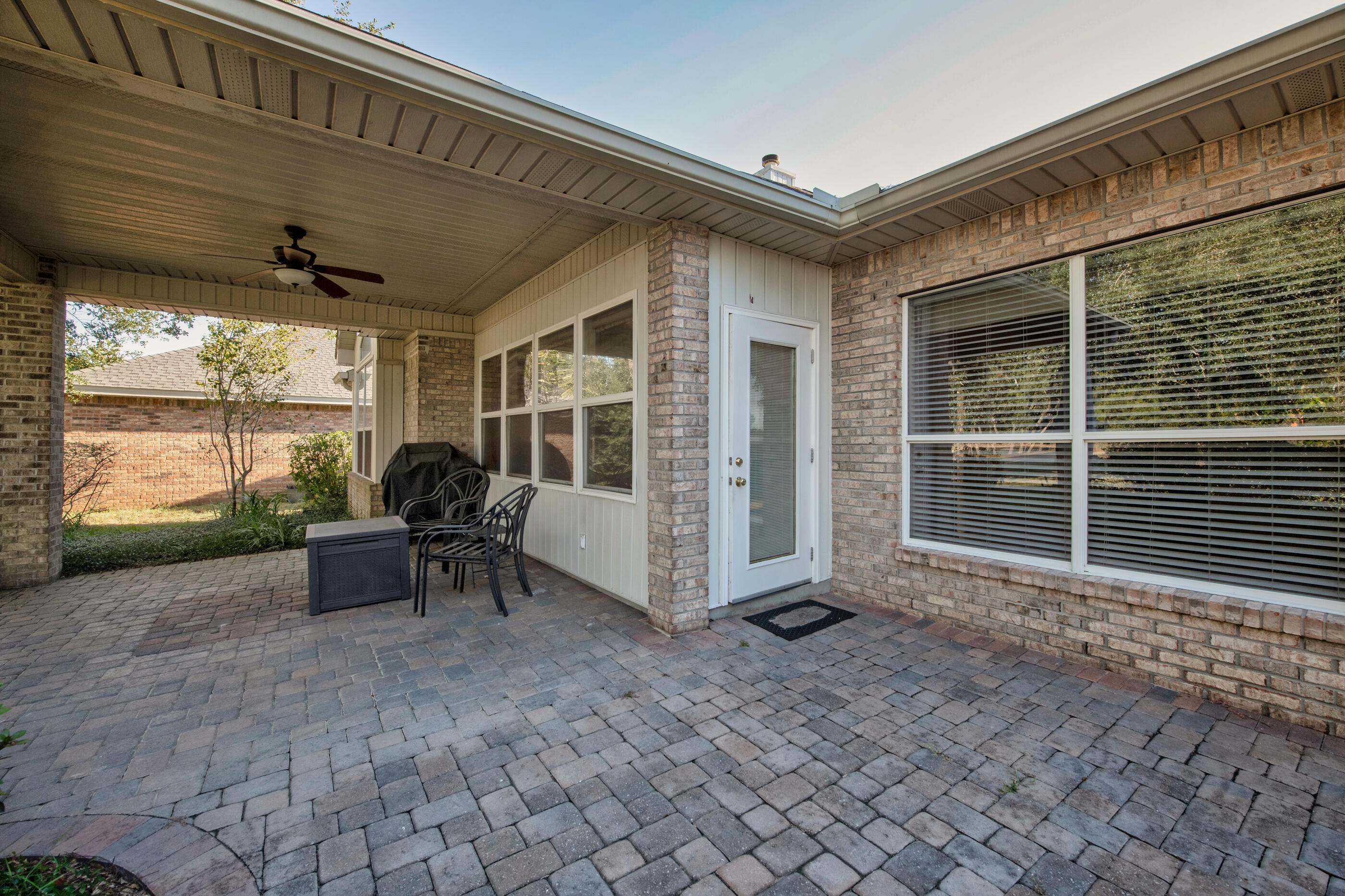 924 Shalimar Point Drive Shalimar, FL 32579 - Photo 34 of 40 a view of a porch with chairs and a yard