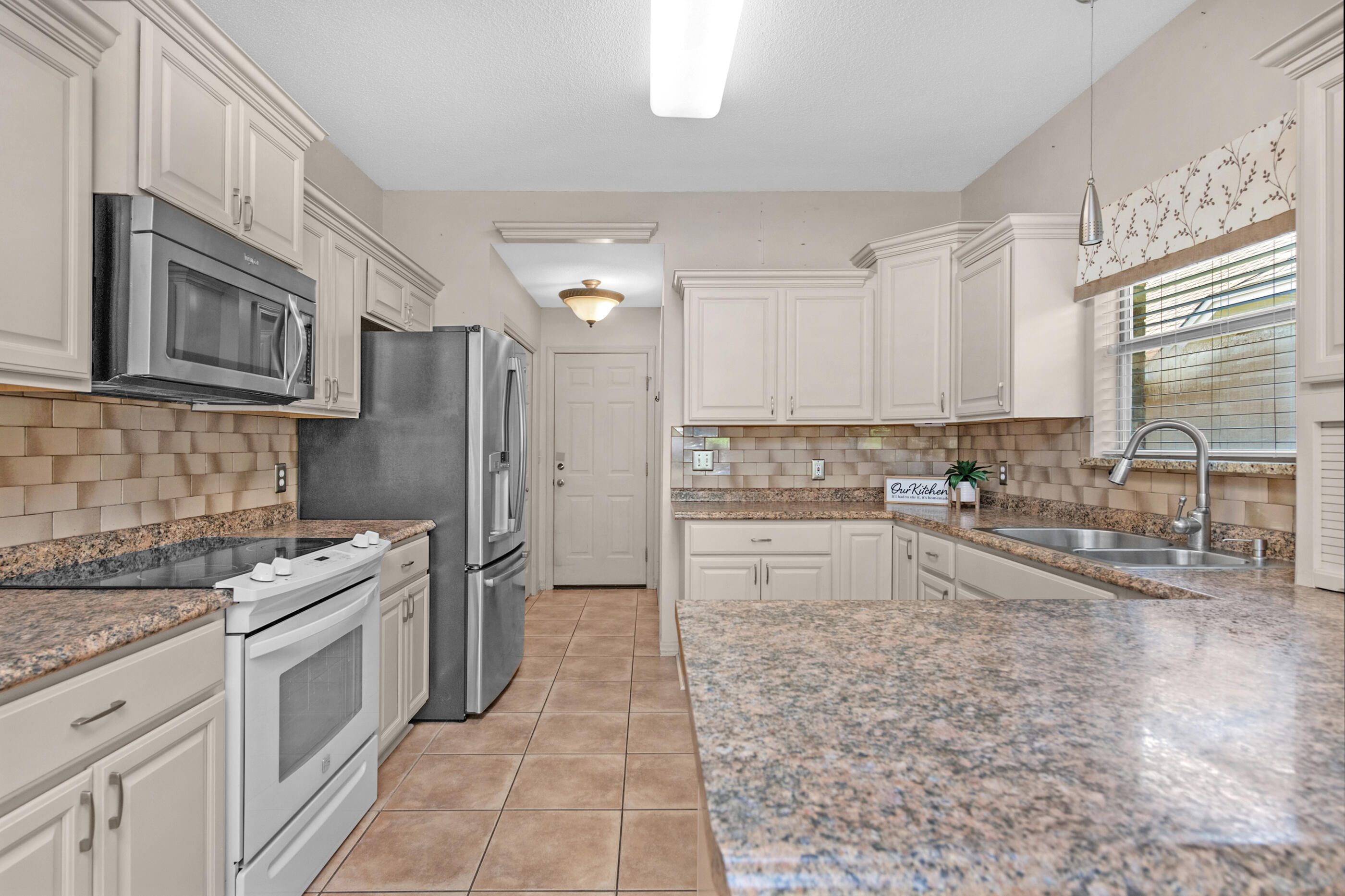 924 Shalimar Point Drive Shalimar, FL 32579 - Photo 5 of 40 a kitchen with stainless steel appliances granite countertop a stove a sink and a refrigerator