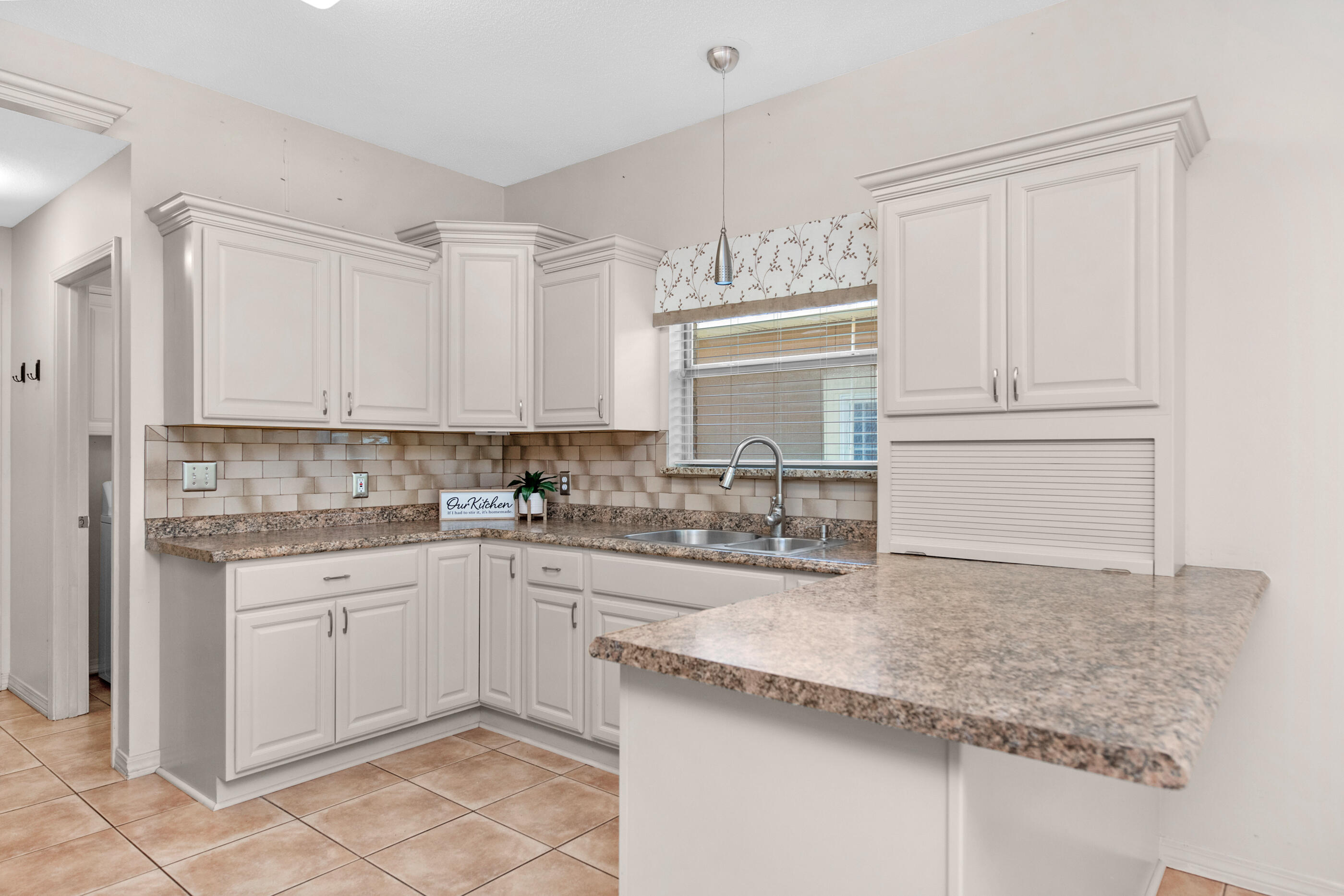 924 Shalimar Point Drive Shalimar, FL 32579 - Photo 6 of 40 a kitchen with granite countertop white cabinets and white appliances