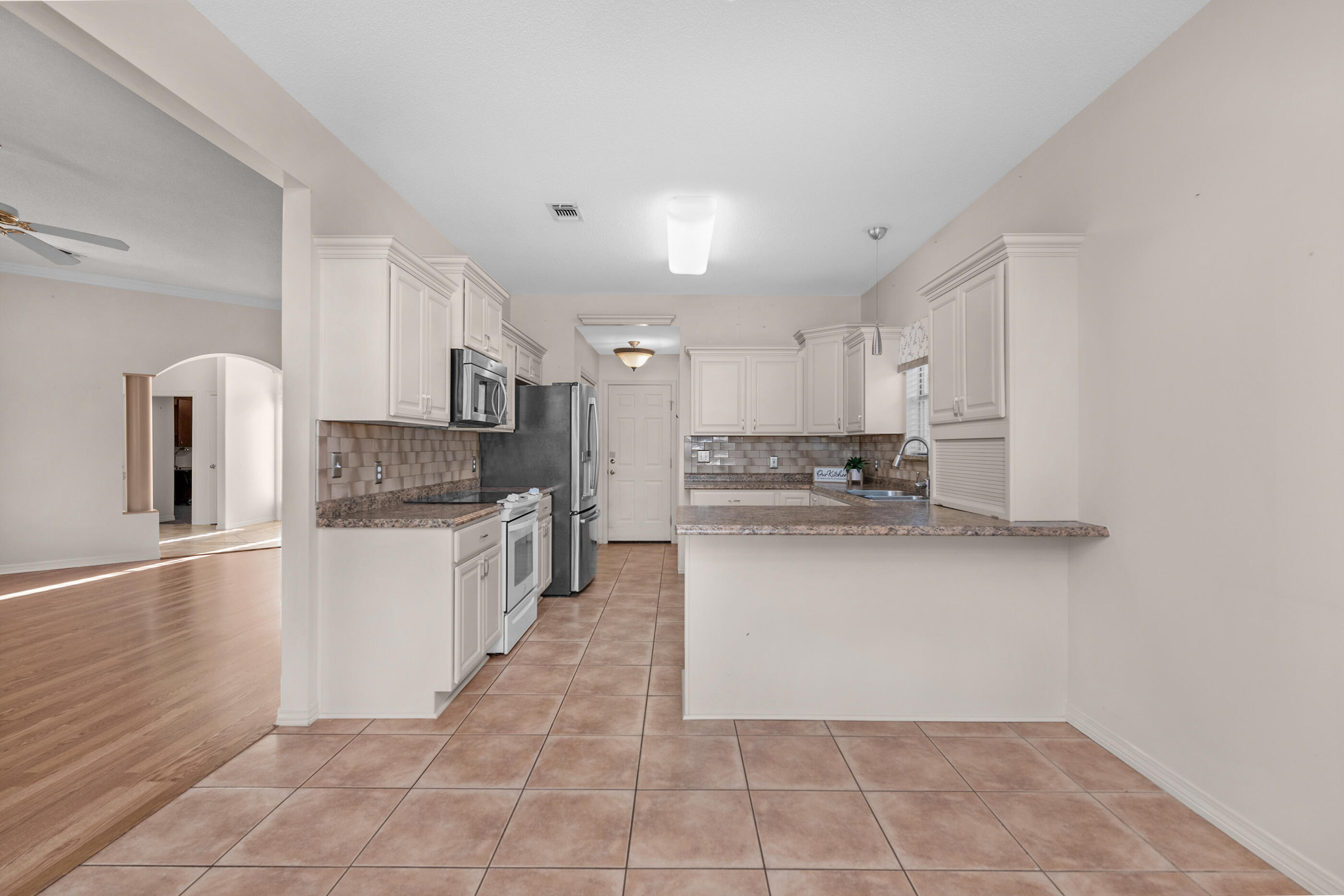 924 Shalimar Point Drive Shalimar, FL 32579 - Photo 10 of 40 a large kitchen with a white stove top oven and white cabinets