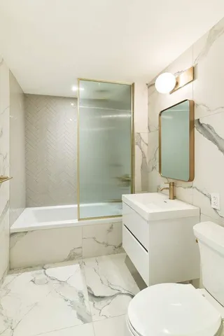 a bathroom with a sink a toilet and bathtub