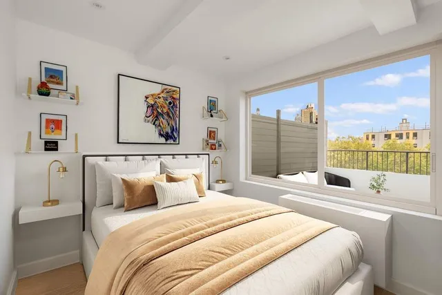 a bedroom with a large bed and a large window