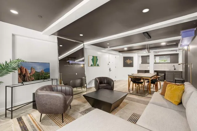 a living room with furniture and wooden floor